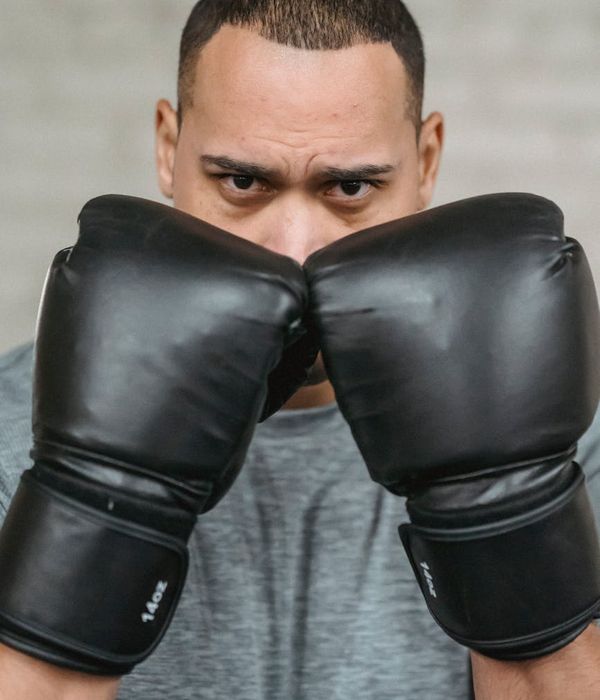 A man focused during a workout, showing concentration and physical effort.